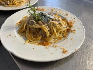 a plate of food with pasta on a table at Hotel la Praia in Zambrone