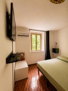a bedroom with a bed and a window at Il Gelsomino Storico in Empoli