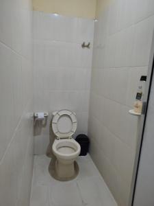a small bathroom with a toilet in a stall at Raíces del Obrero in Honda +3 photos