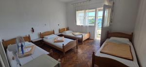 a living room with two beds and a couch at Simple beachfront rooms Bego in Kraljevica +23 photos