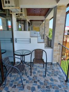 a patio with two chairs and a table at Vila Lara 2 Mai in 2 Mai