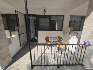 a balcony with a table and two chairs at Vila Lara 2 Mai in 2 Mai