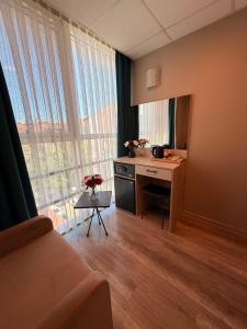 a room with a desk with a mirror and a window at Rota Kadıköy in Istanbul