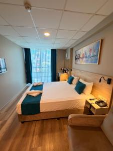a hotel room with a large bed and a couch at Rota Kadıköy in Istanbul +29 photos
