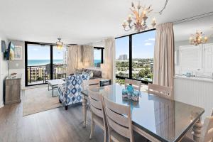 a dining room and living room with a view of the ocean at SunDestin 818 in Destin