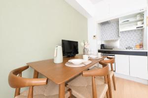 a kitchen with a wooden table and chairs at 宇都宮ハウスシラユリ in Utsunomiya +14 photos