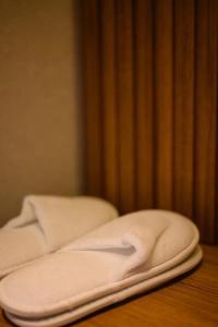two white towels sitting on top of a wooden table at Hera Hotel in Alexandroupoli