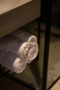 a stack of towels sitting on a shelf at Hera Hotel in Alexandroupoli