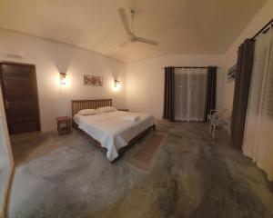 a bedroom with a bed in a room with concrete floors at HillView in Port Mathurin +9 photos