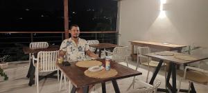 a man sitting at a table in a restaurant at HillView in Port Mathurin