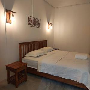 a bedroom with a bed and a table and lights at HillView in Port Mathurin