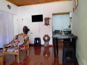 a living room with a table and a television at Brisas de la Bujona in Honda