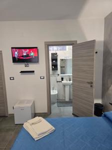 a bedroom with a bed and a tv on the wall at Gli Amici della Puglia 2 in Taranto +66 photos