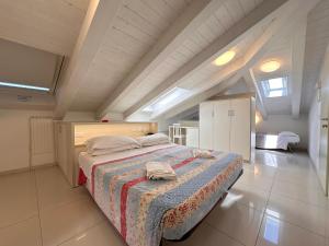 a large bedroom with a bed in an attic at Hotel Leoni in Rimini +70 photos