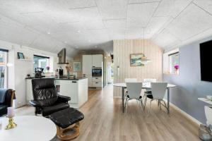 a kitchen and living room with a table and chairs at FY180-Asperup-Daadyrvaenget-18 in Asperup