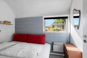 a small bedroom with a bed and a window at FY180-Asperup-Daadyrvaenget-18 in Asperup