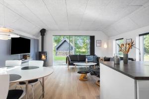 a living room with a couch and a table at FY180-Asperup-Daadyrvaenget-18 in Asperup