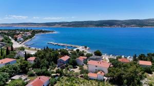 an aerial view of a small town next to a body of water at Vila Velebita in Seline +33 photos