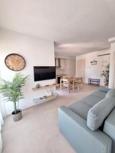 a living room with a blue couch and a table at Onde e Relax D&D in Marina di Bibbona