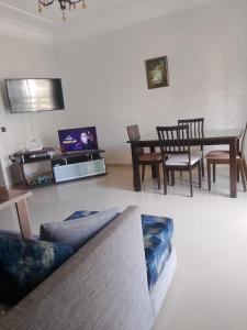 a living room with a couch and a table at Appartement vu sur Mer in Mohammedia