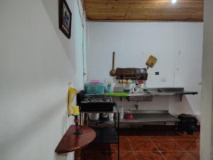 a kitchen with a counter and a table in a room at Remanso del Río in Honda