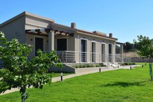 a house with a lawn in front of it at Saonia Apartment in Samothraki