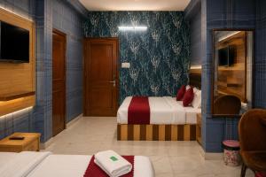 a hotel room with two beds and a tv at Jannat Hotel - Solan in Solan