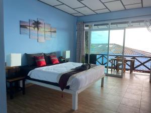 a bedroom with a bed and a view of the ocean at Rock sand Resort in Trat