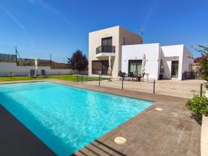 a villa with a swimming pool in front of a house at Casa Solaria Córdoba in Guadalcázar