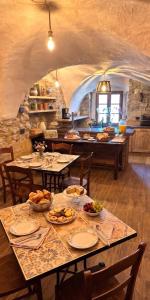 a dining room with tables and chairs with food on them at Le Orme in Tenno
