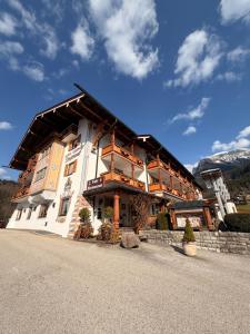 a large building with a gambrel roof at Hotel Bergheimat in Schönau am Königssee