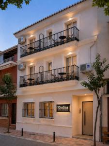 a white building with a sign in front of it at 10ToSea Premium Hostal in Fuengirola