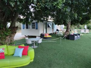 a green couch sitting in the grass in front of a house at The Place in Albufeira