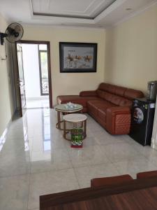 a living room with a couch and a table at Nhà khách 705 in Mộc Châu
