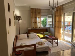 a bedroom with a bed and a table in it at Watermelon Home in Nea Moudania
