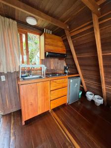 a kitchen with a sink and a stove in a cabin at Cabaña en Jericó in Jericó