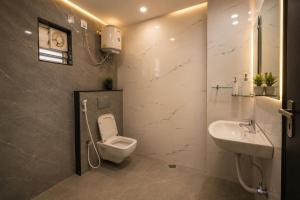 a bathroom with a toilet and a sink at Hotel cressida green palace - near redisson squar in Indore