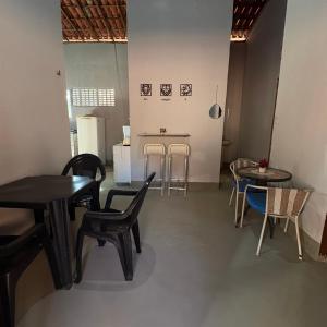 a dining room with two tables and chairs and a table at Praia de Pitangui in Extremóz