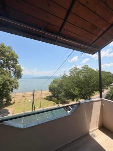 a view of the ocean from the balcony of a house at Apartments President in Star Dojran