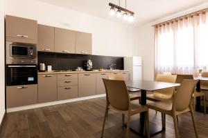 a kitchen with a table and a dining room at kalispera in Cinisi