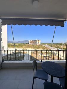 a balcony with a table and chairs and a view at Adan Luxury Aparthotel in Orikum