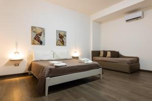 a room with two beds and a couch in it at kalispera in Cinisi +117 photos