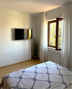 a bedroom with a bed and a flat screen tv at Apartment Dalmare in Biograd na Moru