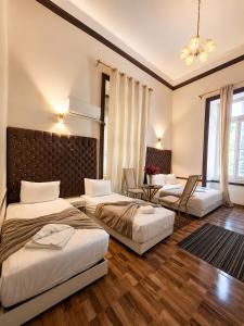 a bedroom with two beds and a living room at Velvet city view in Cairo