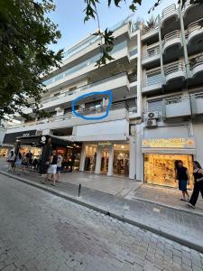 a building with people walking in front of a store at Cozy Suite in Rhodes Town