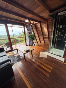 a room with a couch and a table and windows at Cabaña en Jericó in Jericó +11 photos