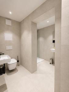 a bathroom with a toilet and a sink at Oceanview Residences Lauterbach Rügen Ostsee erste Reihe in Putbus +49 photos
