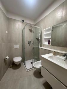 a bathroom with a shower and a toilet and a sink at Residenze Coda Cavallo in San Teodoro +218 photos