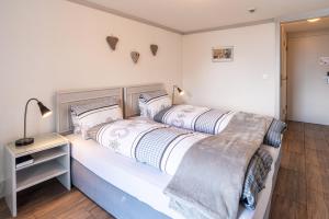 a bedroom with two beds and a lamp on a table at Double Room by Interlaken. Parking in Därligen
