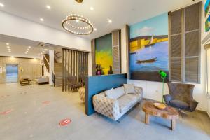 a living room with a couch and a table at Bodrum Fora Holiday Resort in Bodrum City